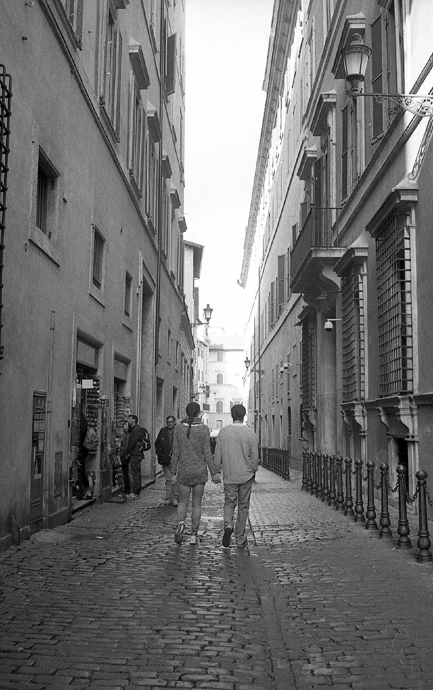 Street in Rome and two people walking side by side