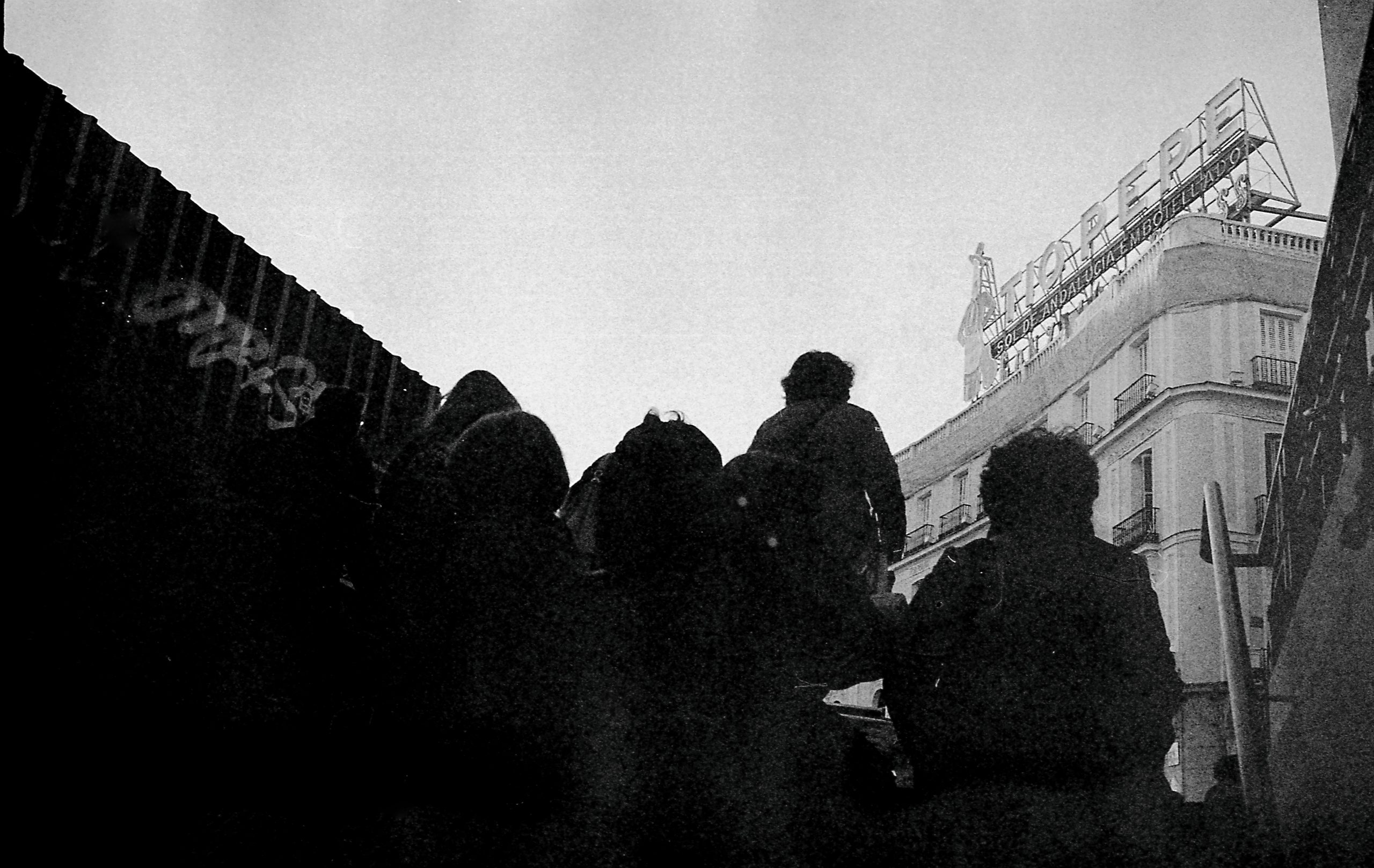 Black and white picture of people coming out of a subway station